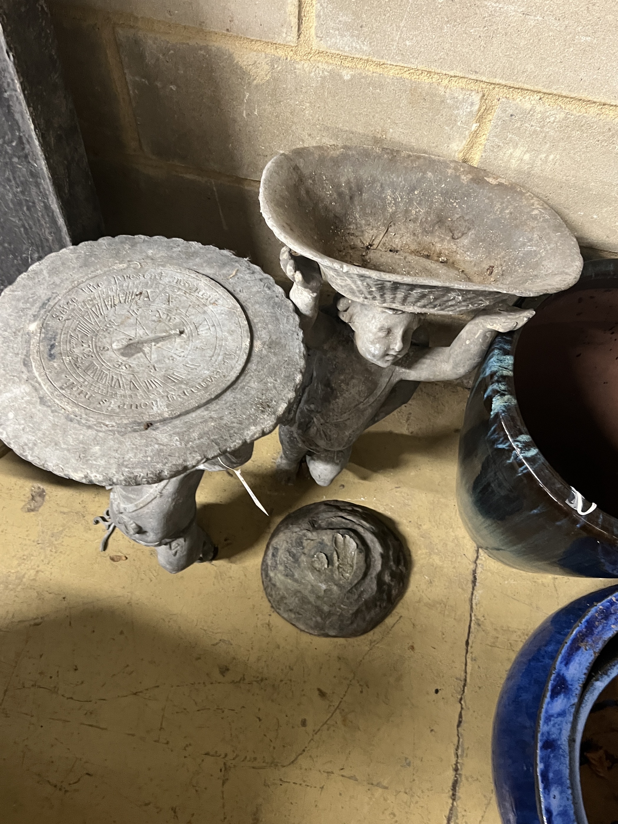Two Victorian lead garden putto figures, one as a sundial, the other a birdbath, in need of restoration, larger height 69cm